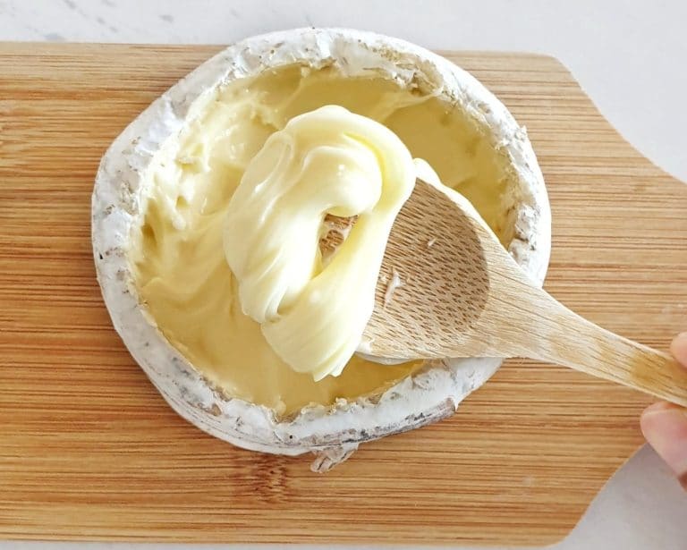 Oozy Driftwood soft cheese being scooped up with wooden spoon